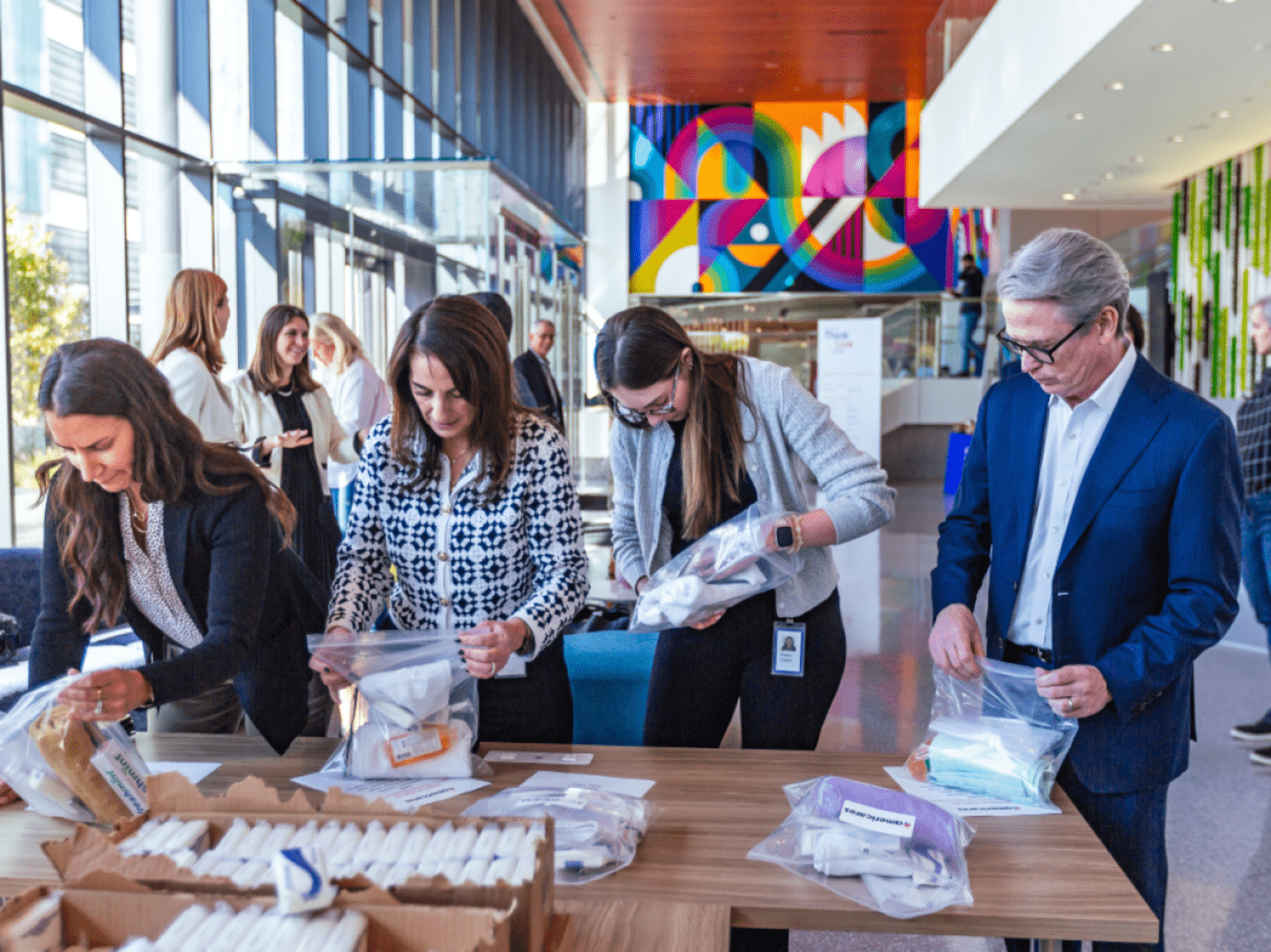 Team working with packages at Cencora headquarters.