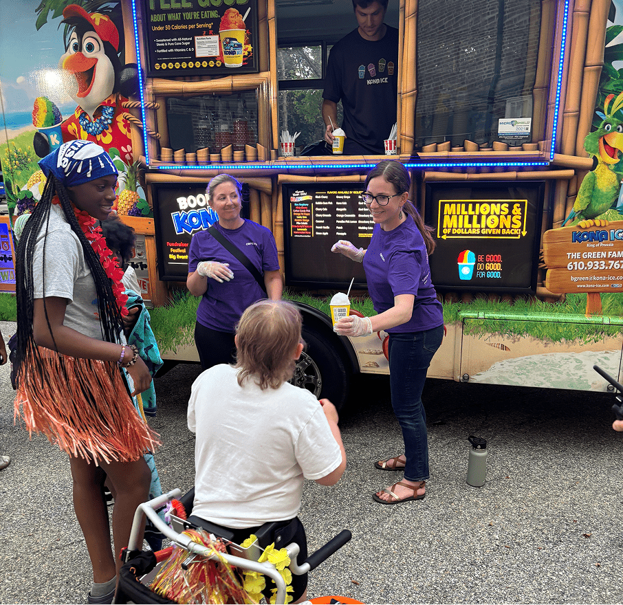 People buying ice cream from an ice cream cart.