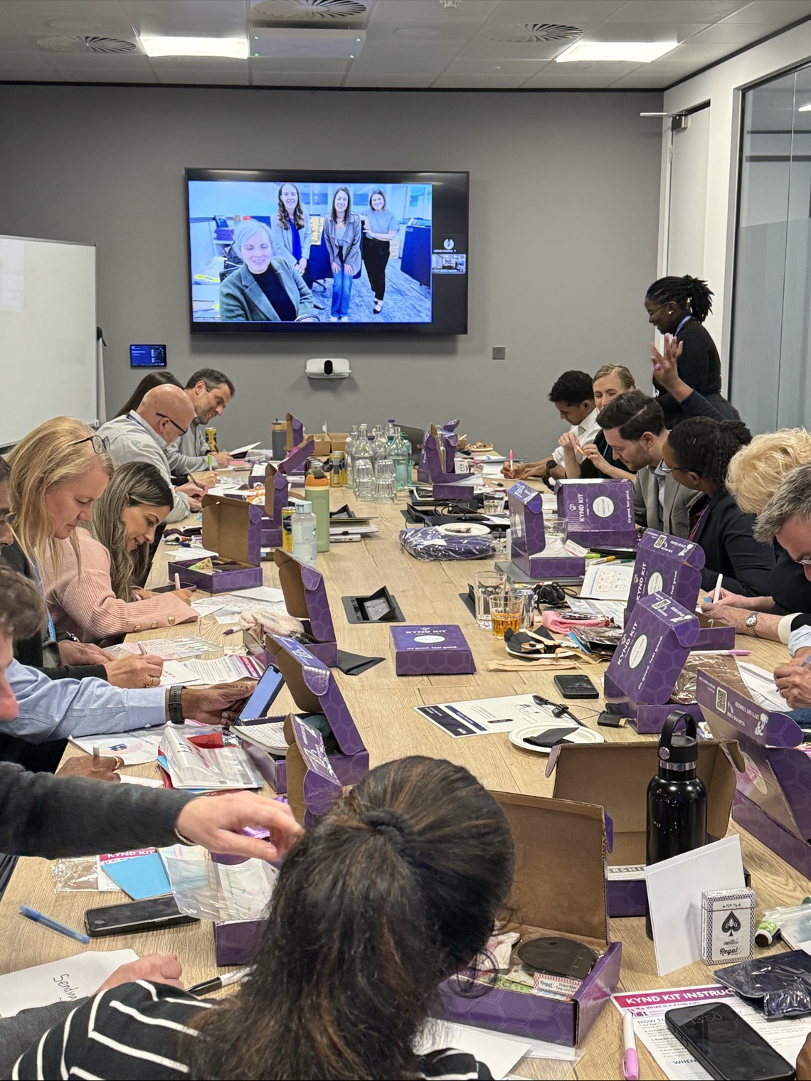 Team members working together in a meeting room.