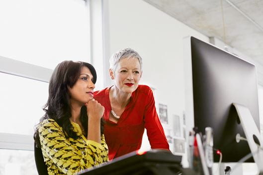 Two Cencora colleagues working in front of workstation